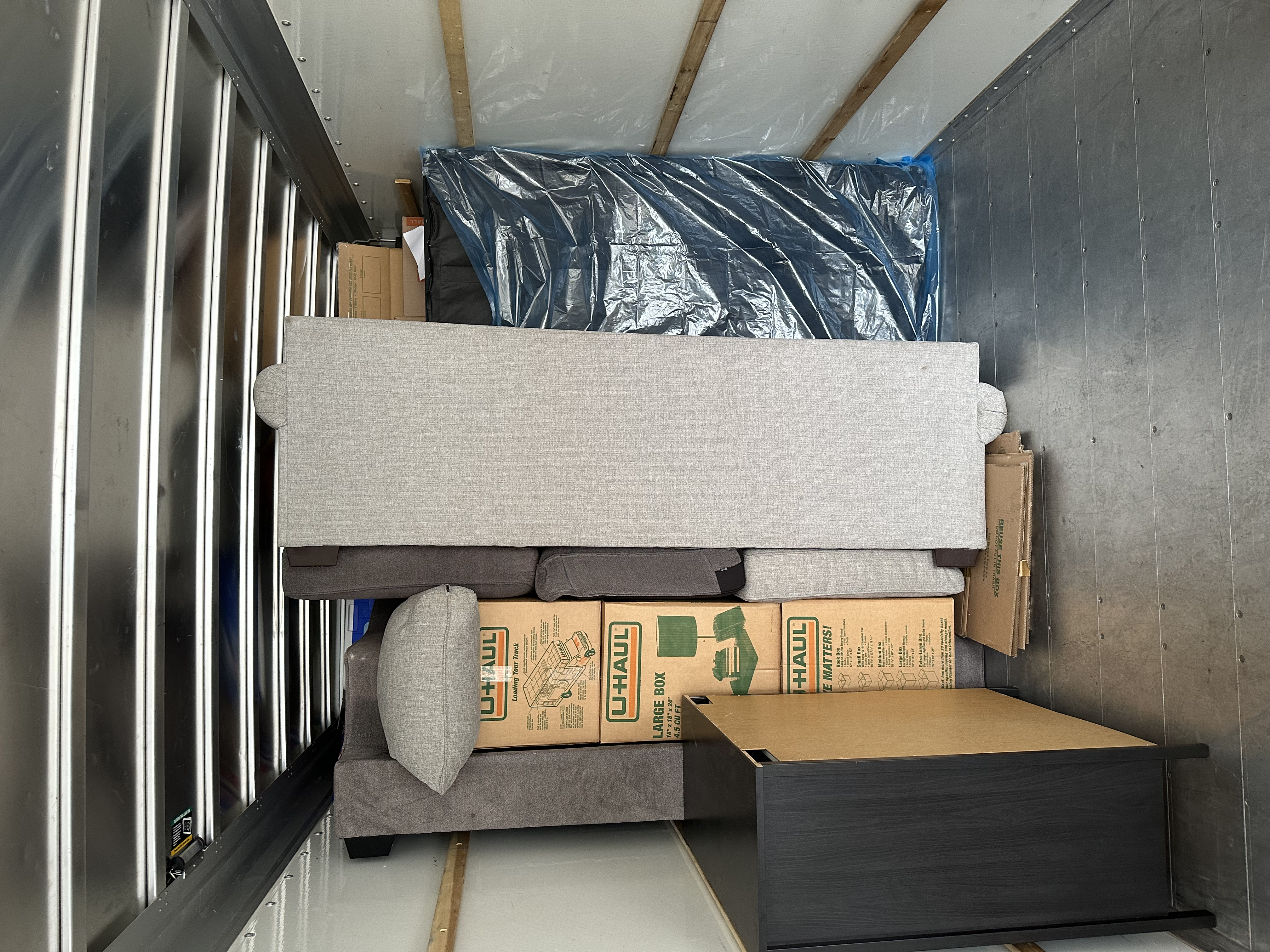 Truck loaded with wrapped furniture and boxes