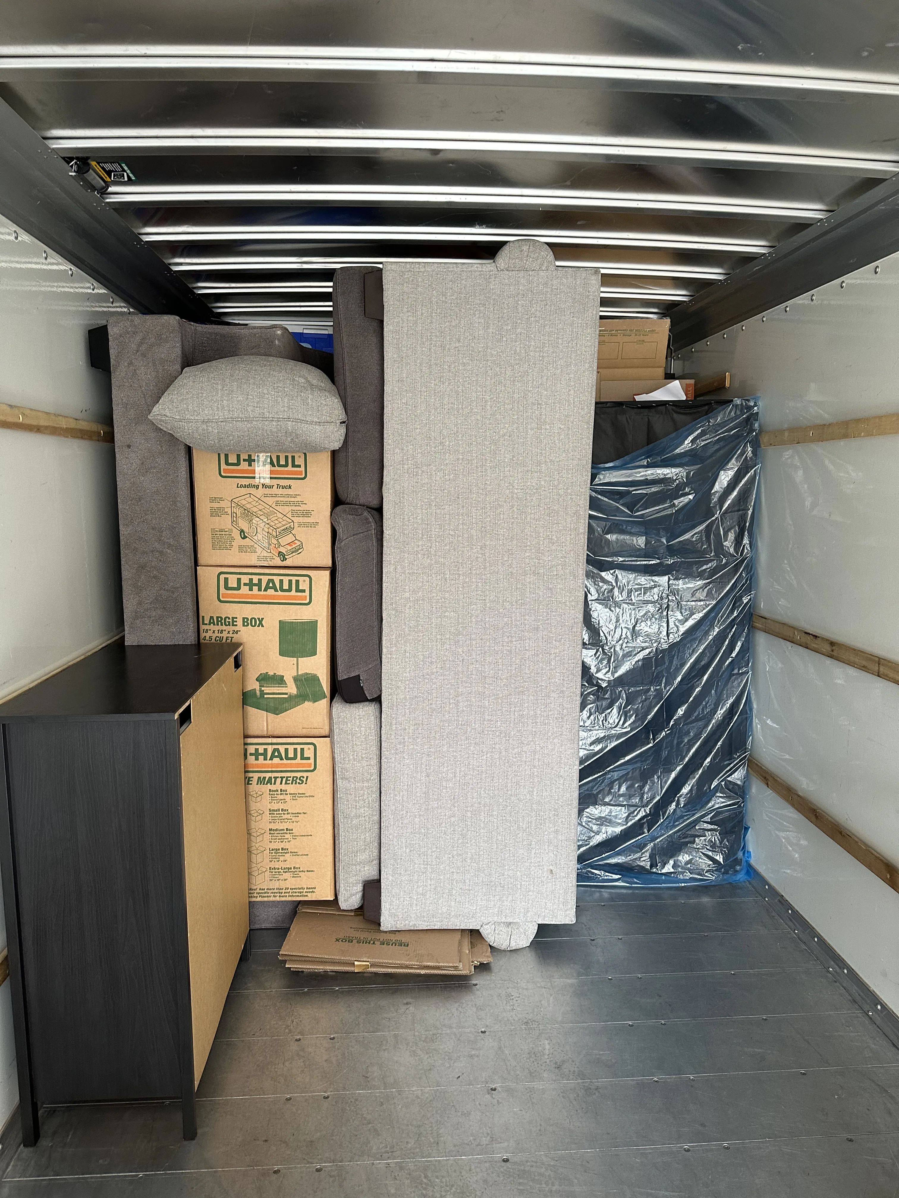 Truck loaded with wrapped furniture and boxes