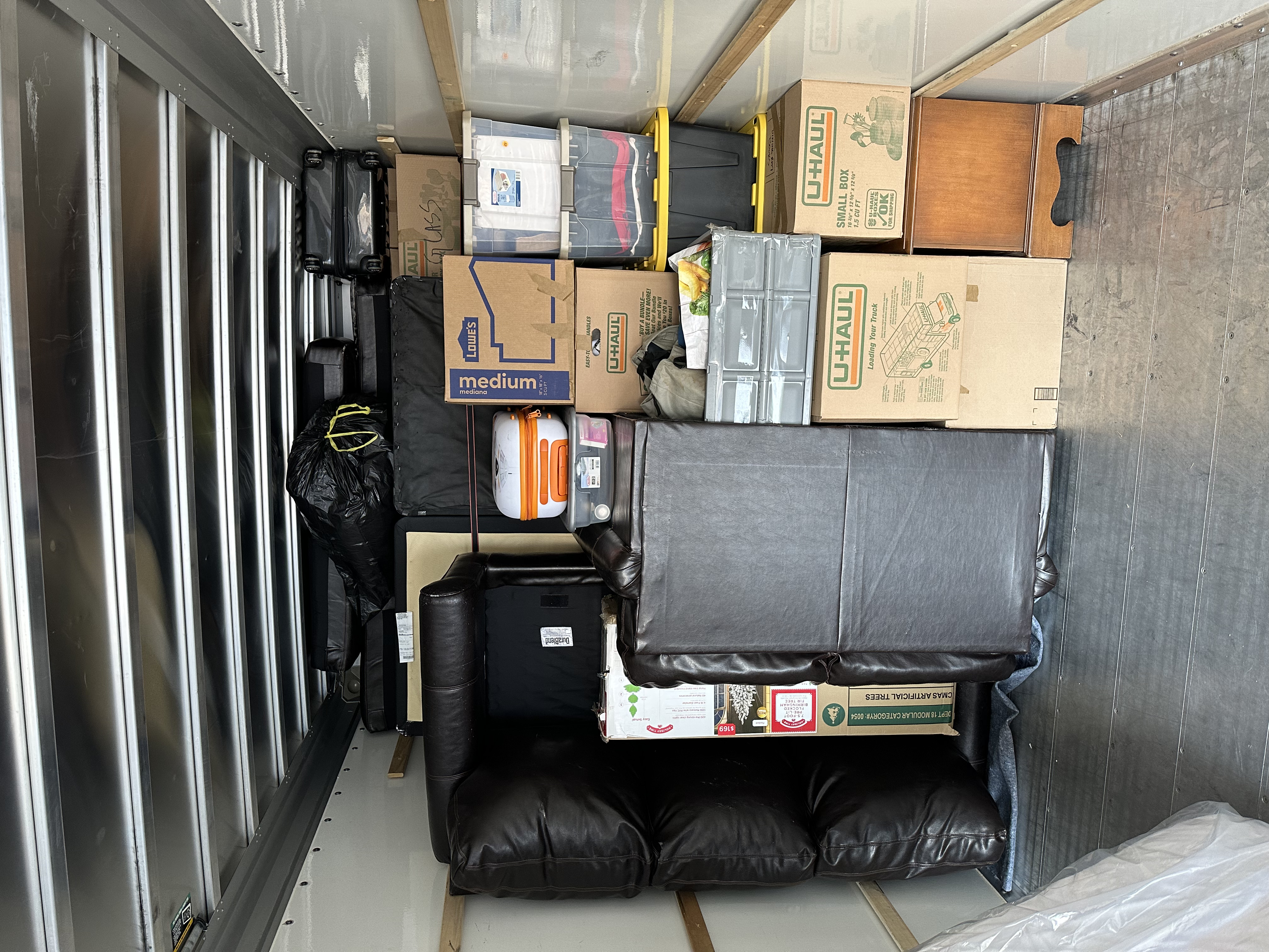 Full truck — multiple layers of boxes and furniture