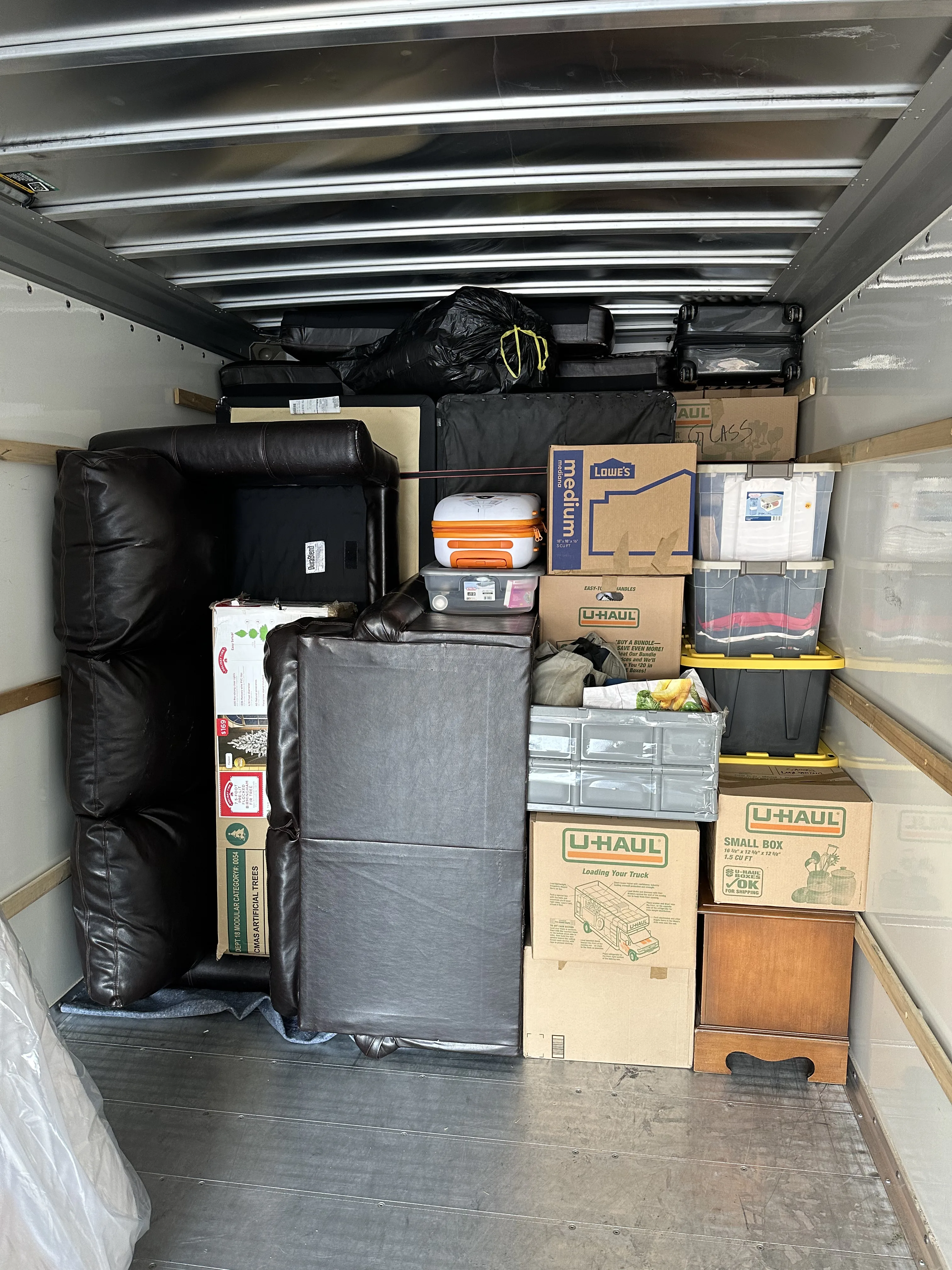 Full truck — multiple layers of boxes and furniture