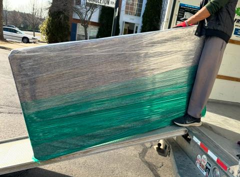 Mattress wrapped and loaded onto ramp