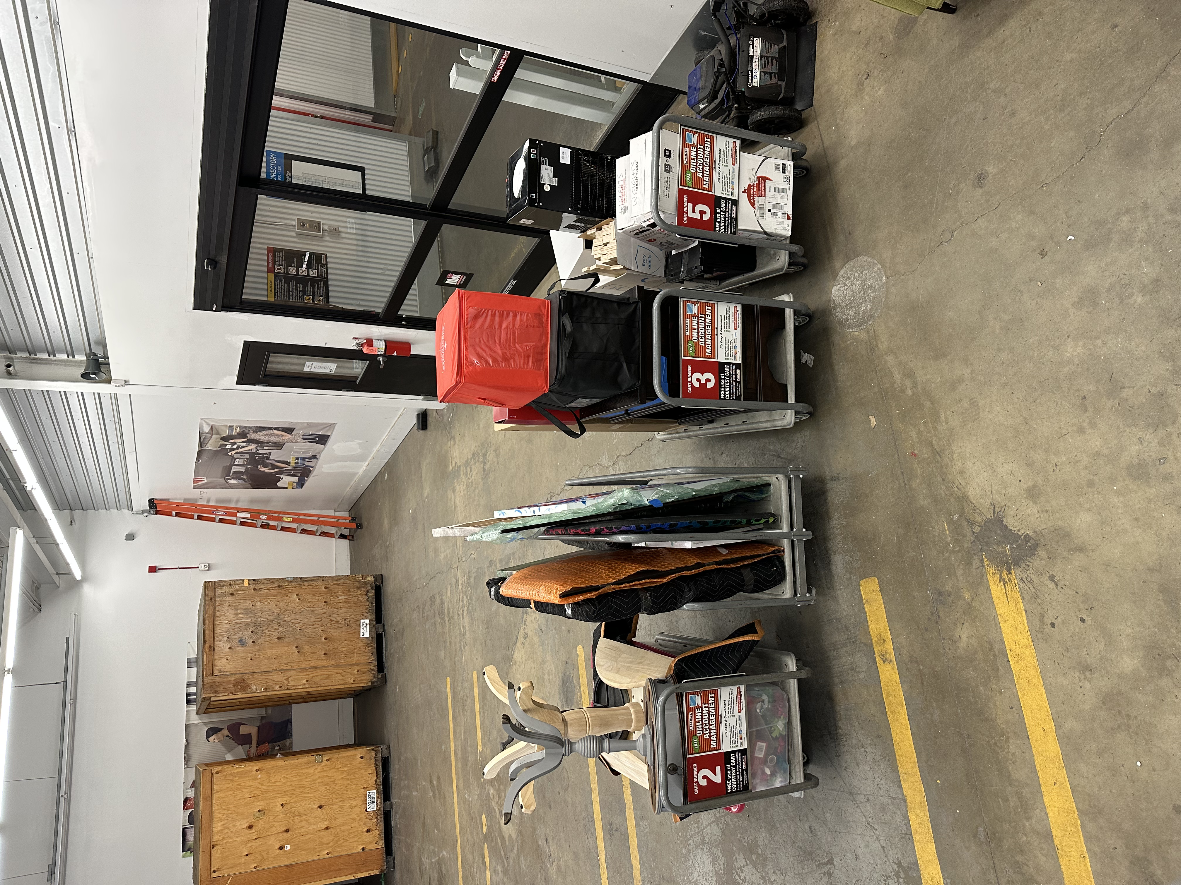 Overhead shelf organized with soft goods and boxes