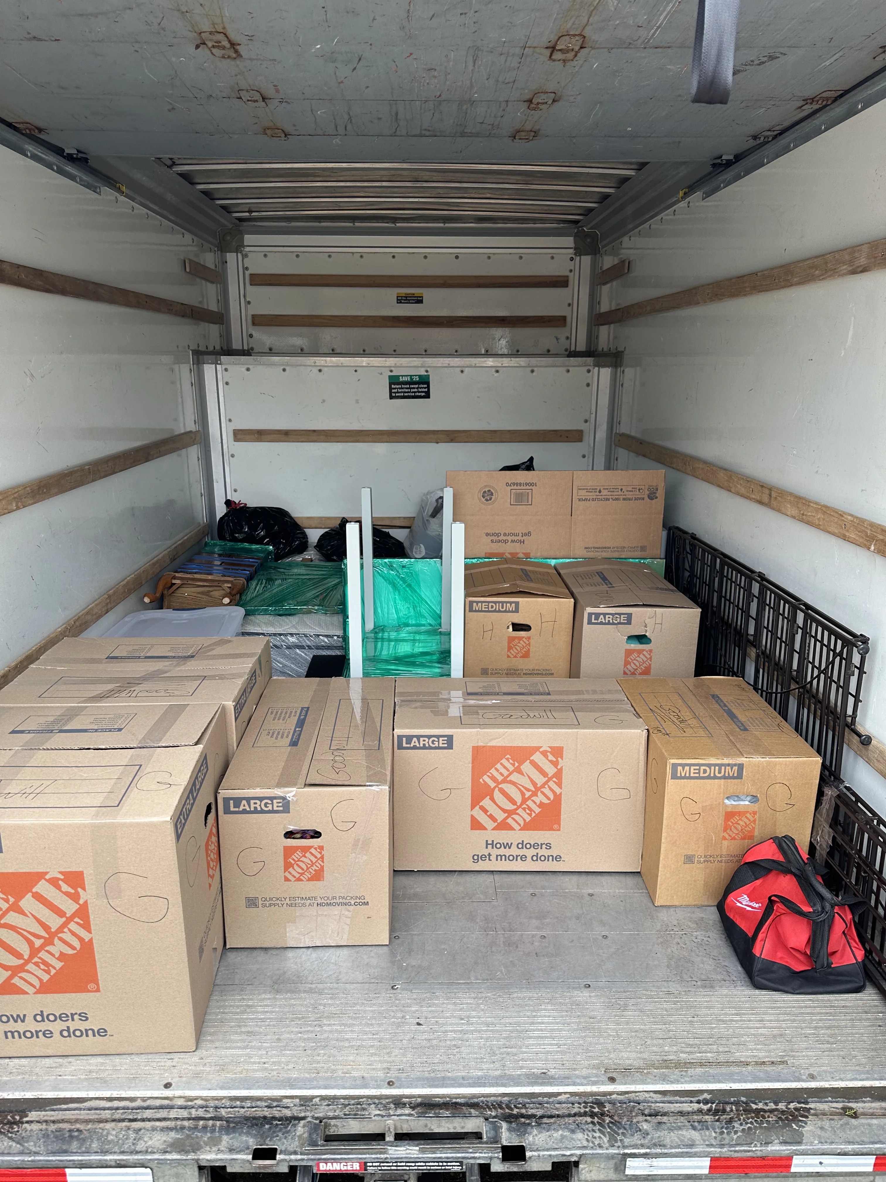 Truck loaded with Home Depot boxes and furniture