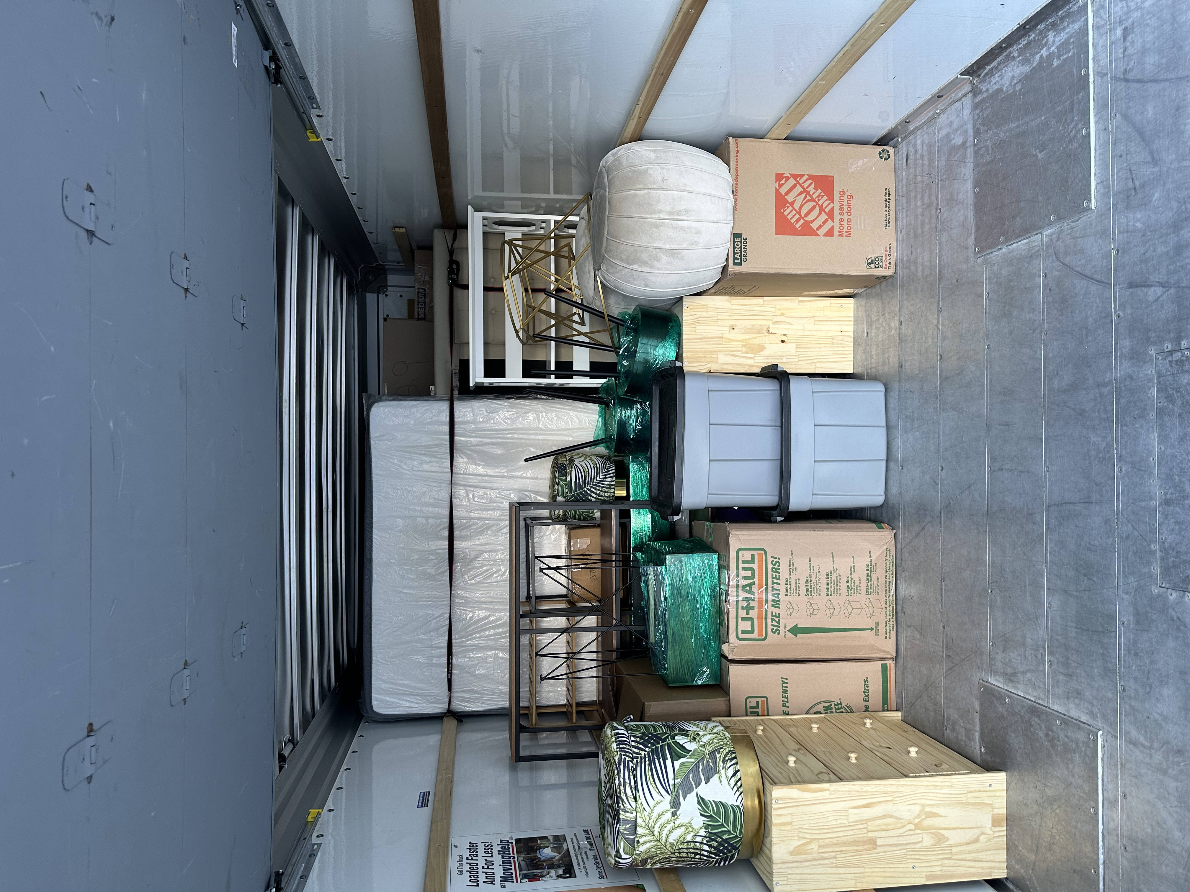 Organized truck interior with mattress and shelving