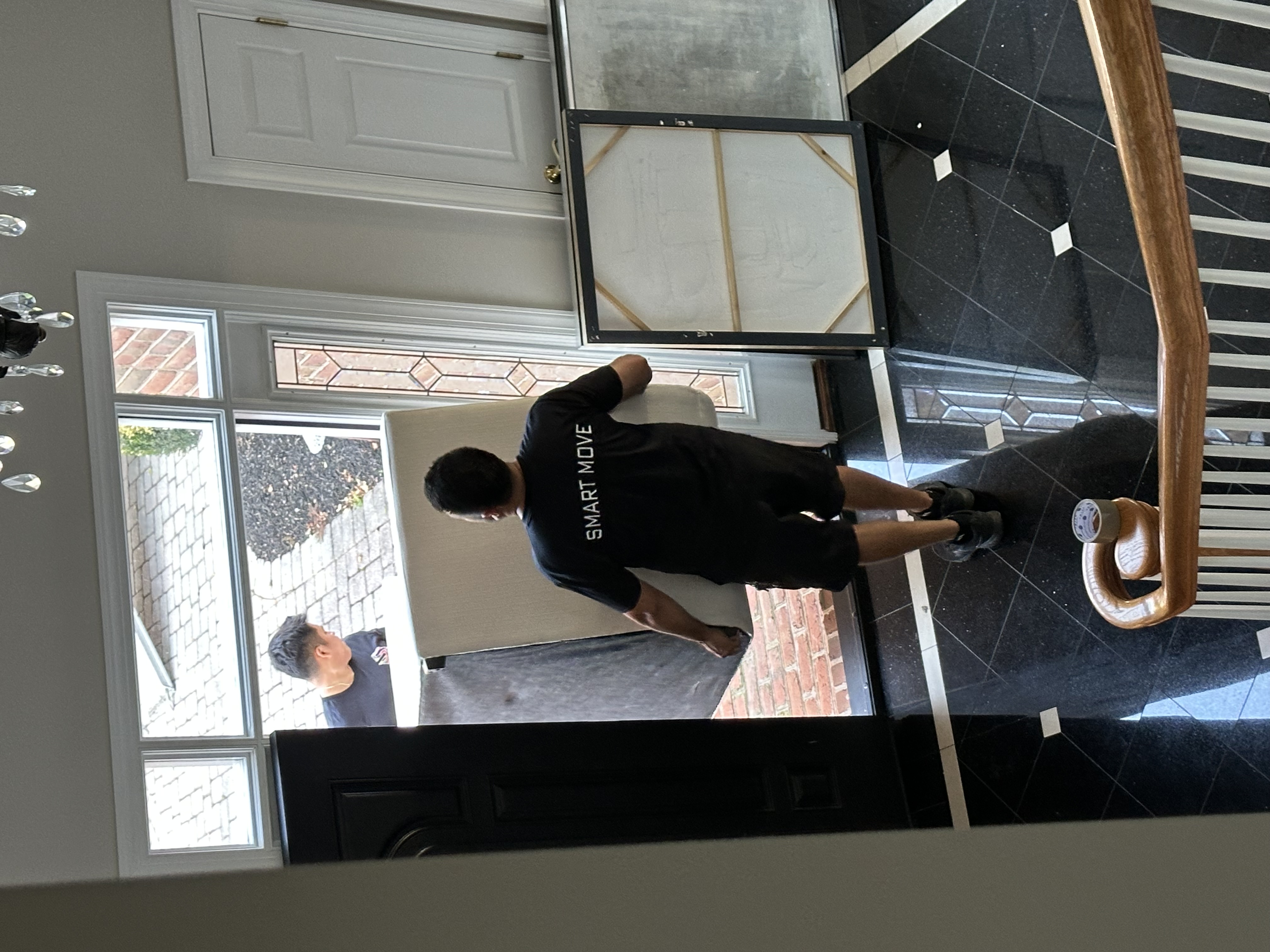 Smart Move crew carrying furniture through front door