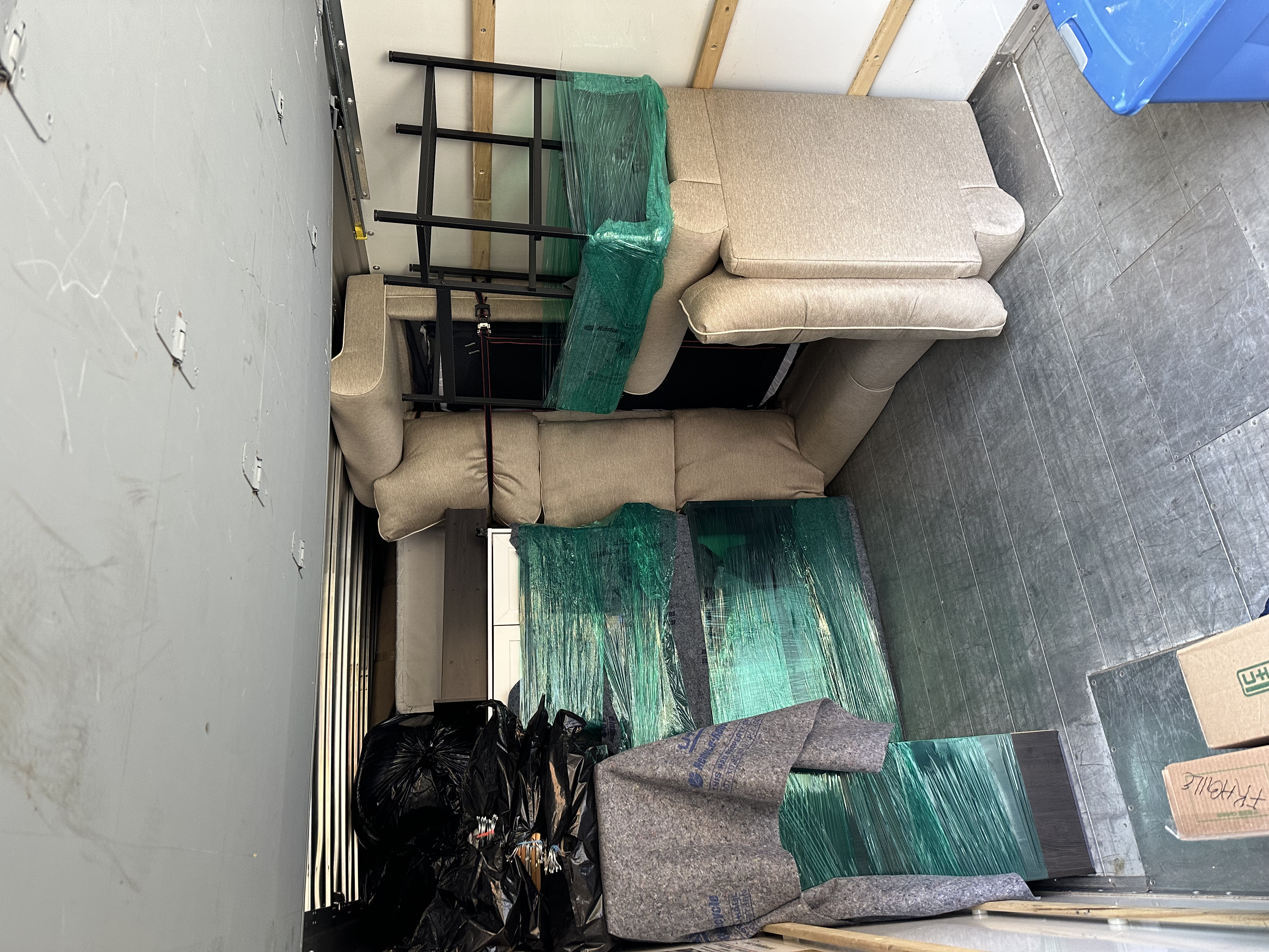 Sectional sofa and shelving loaded securely