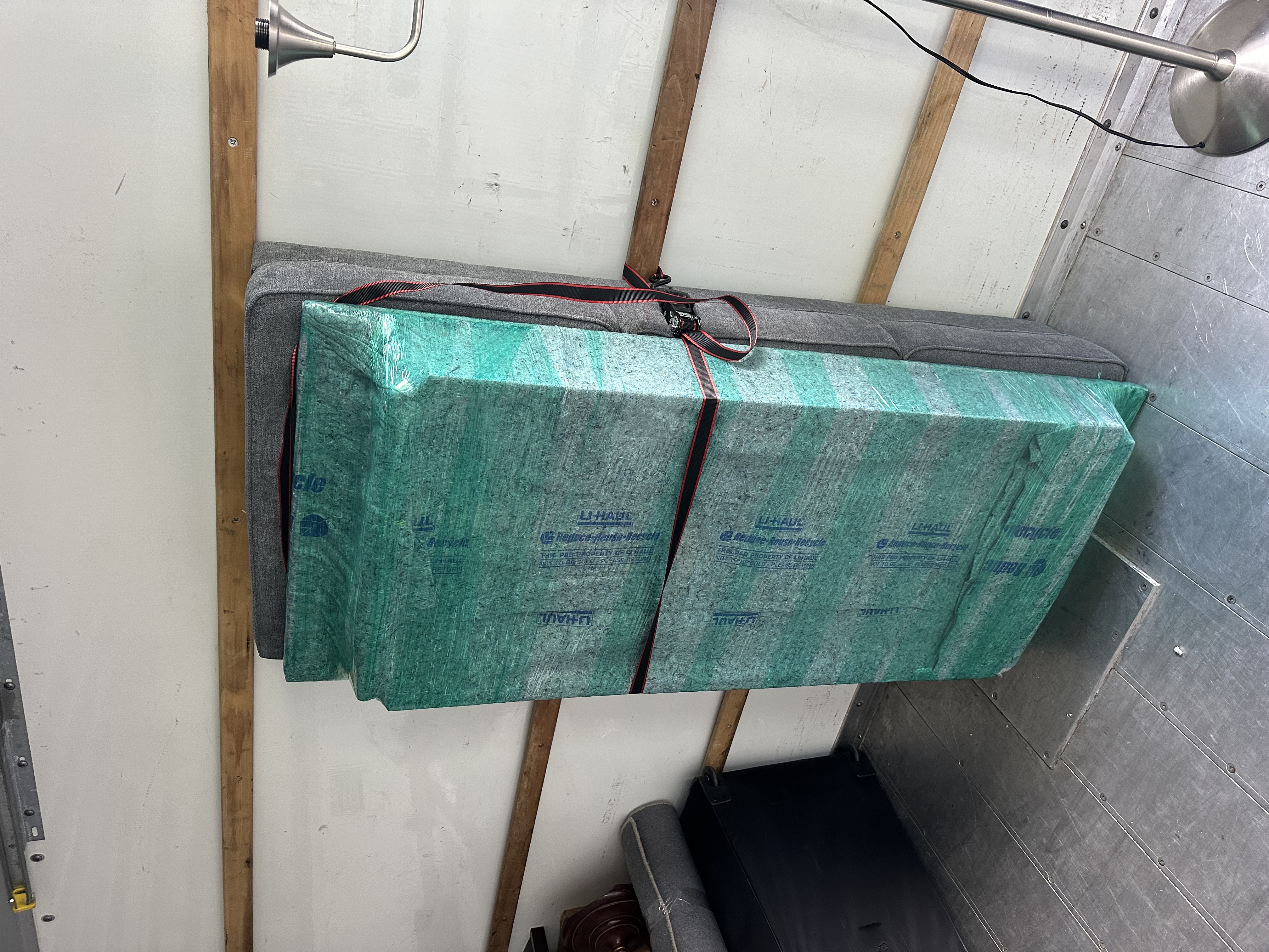 Mattress and furniture wrapped in moving pads