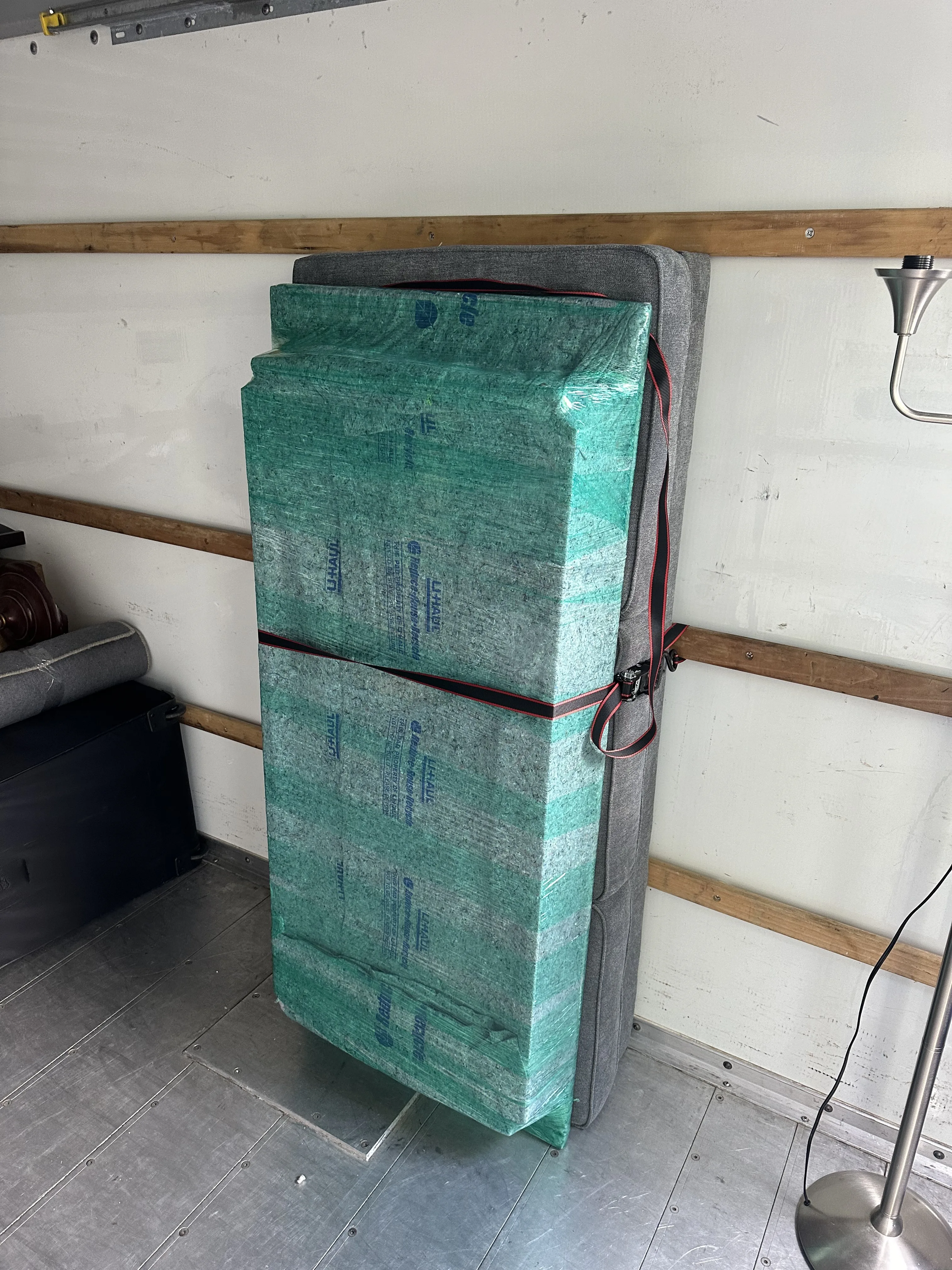 Mattress and furniture wrapped in moving pads