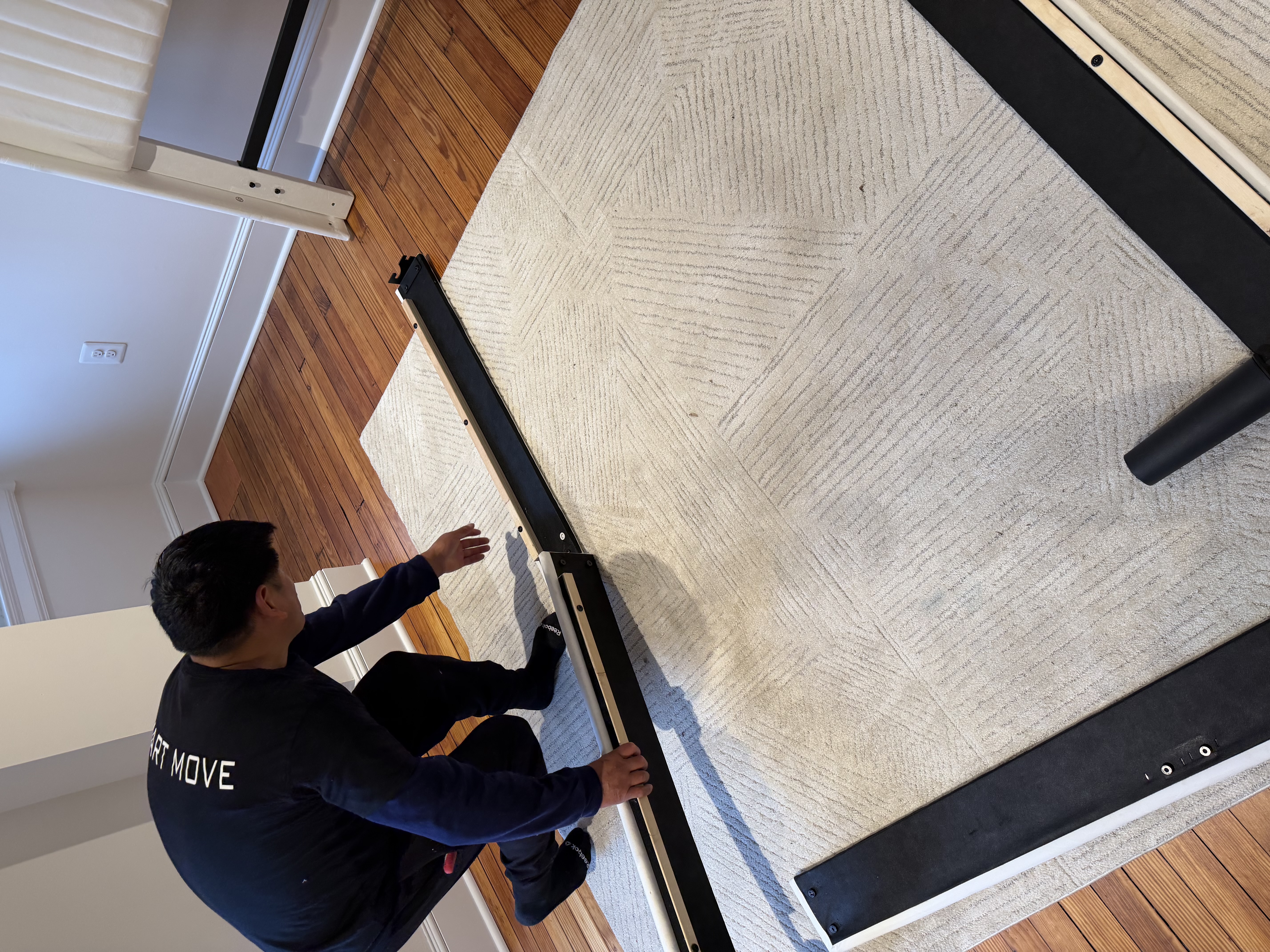 Team member assembling bed frame on-site