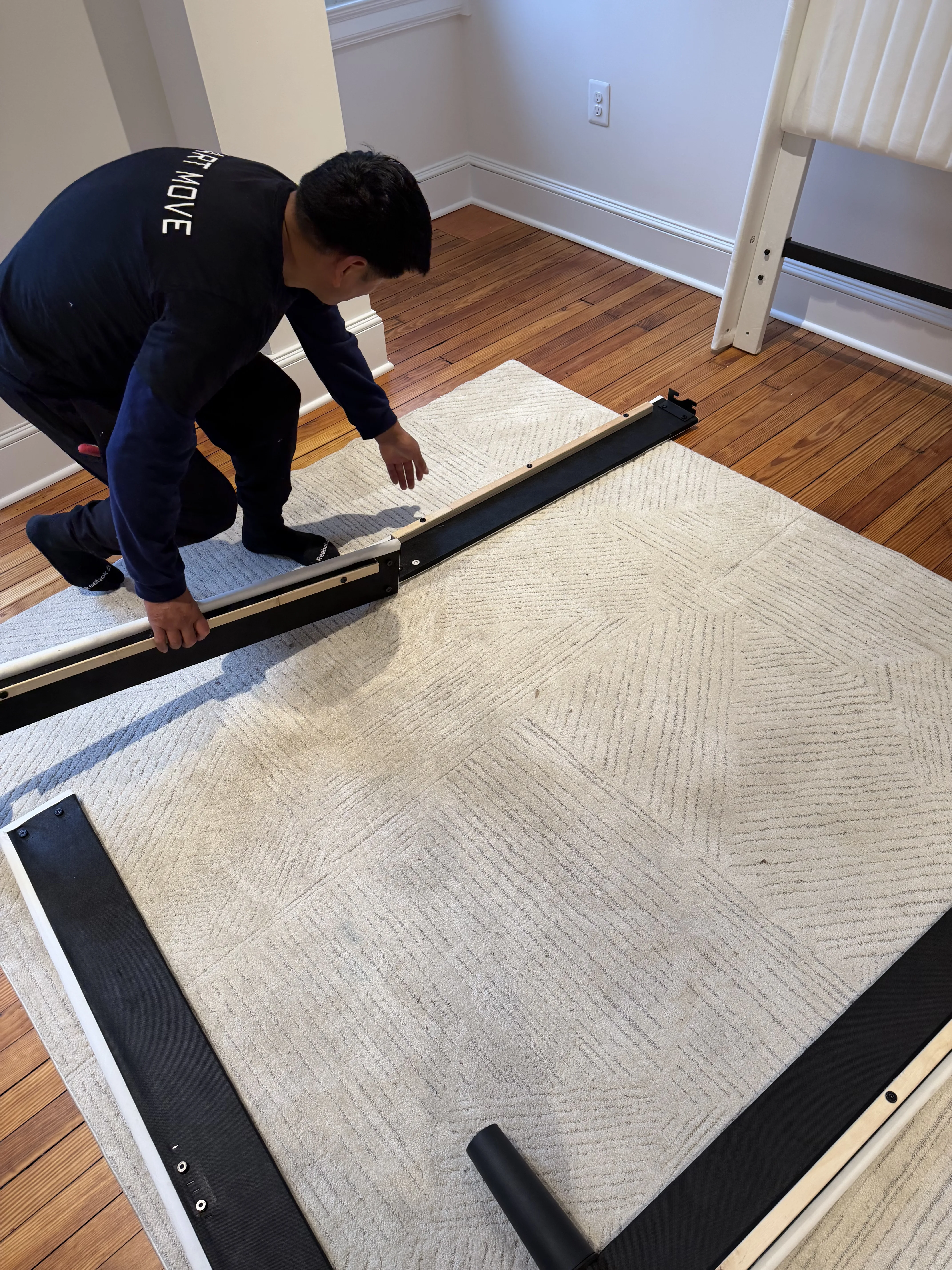 Team member assembling bed frame on-site