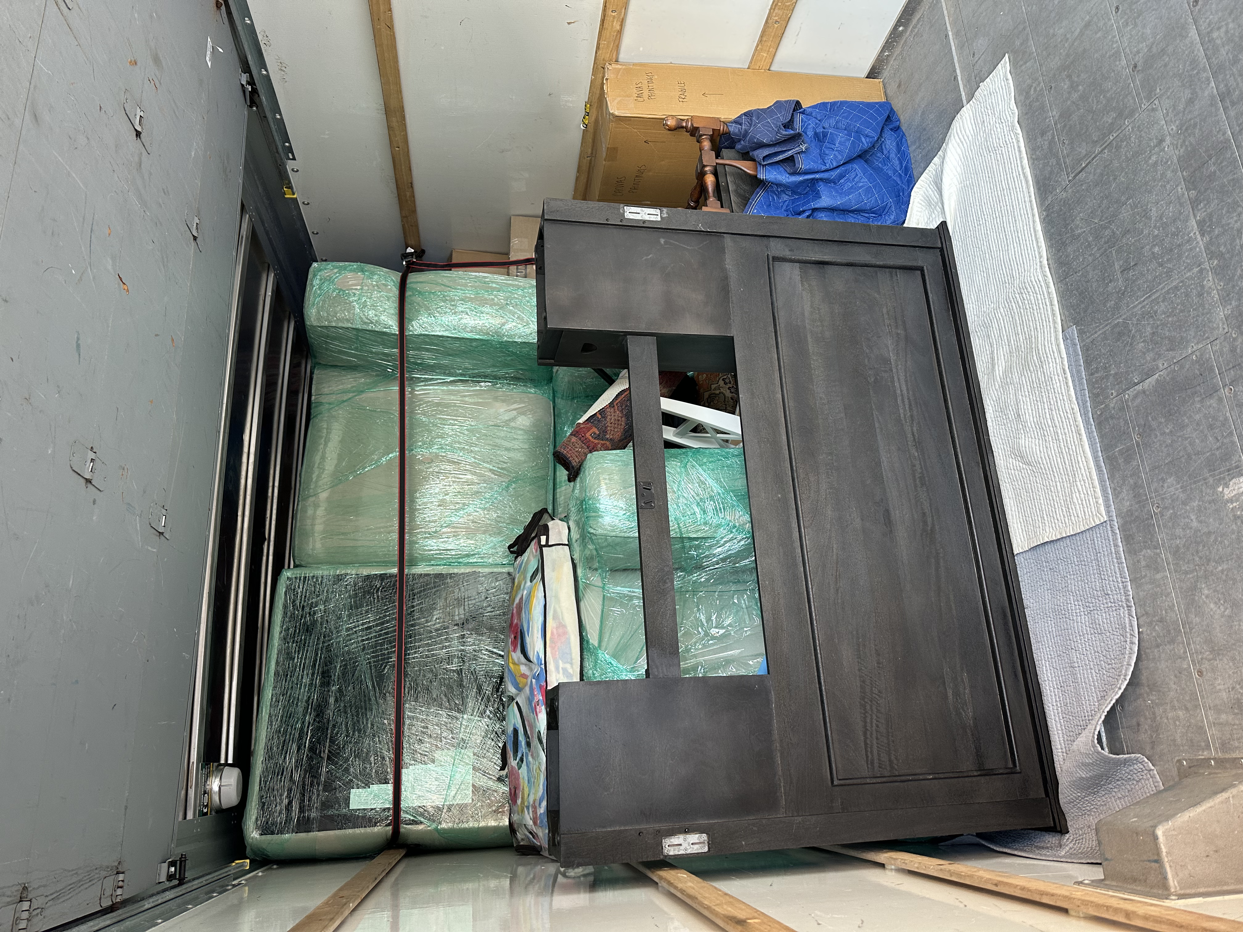 Truck interior with dresser and wrapped furniture