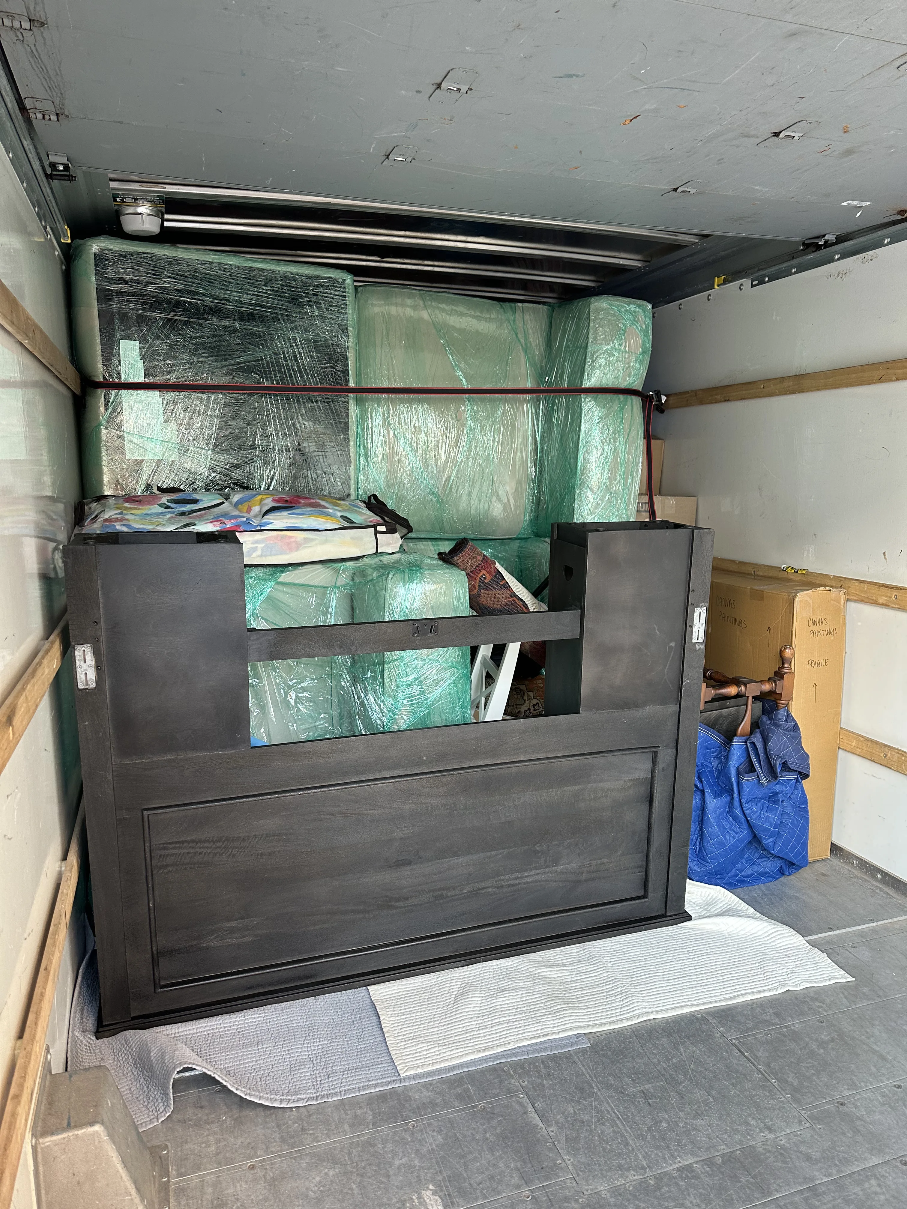 Truck interior with dresser and wrapped furniture