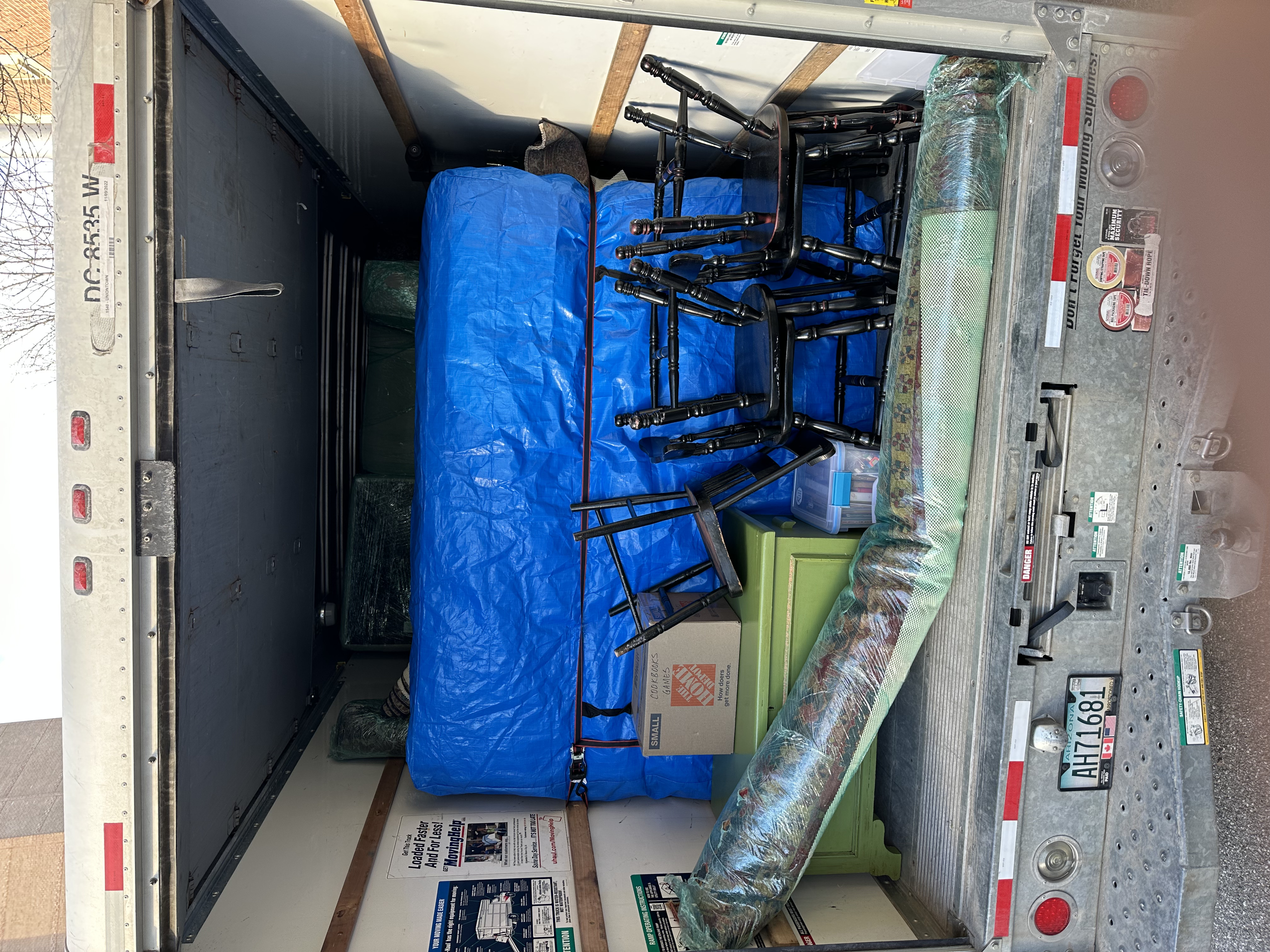 Loaded truck — chairs and mattress secured