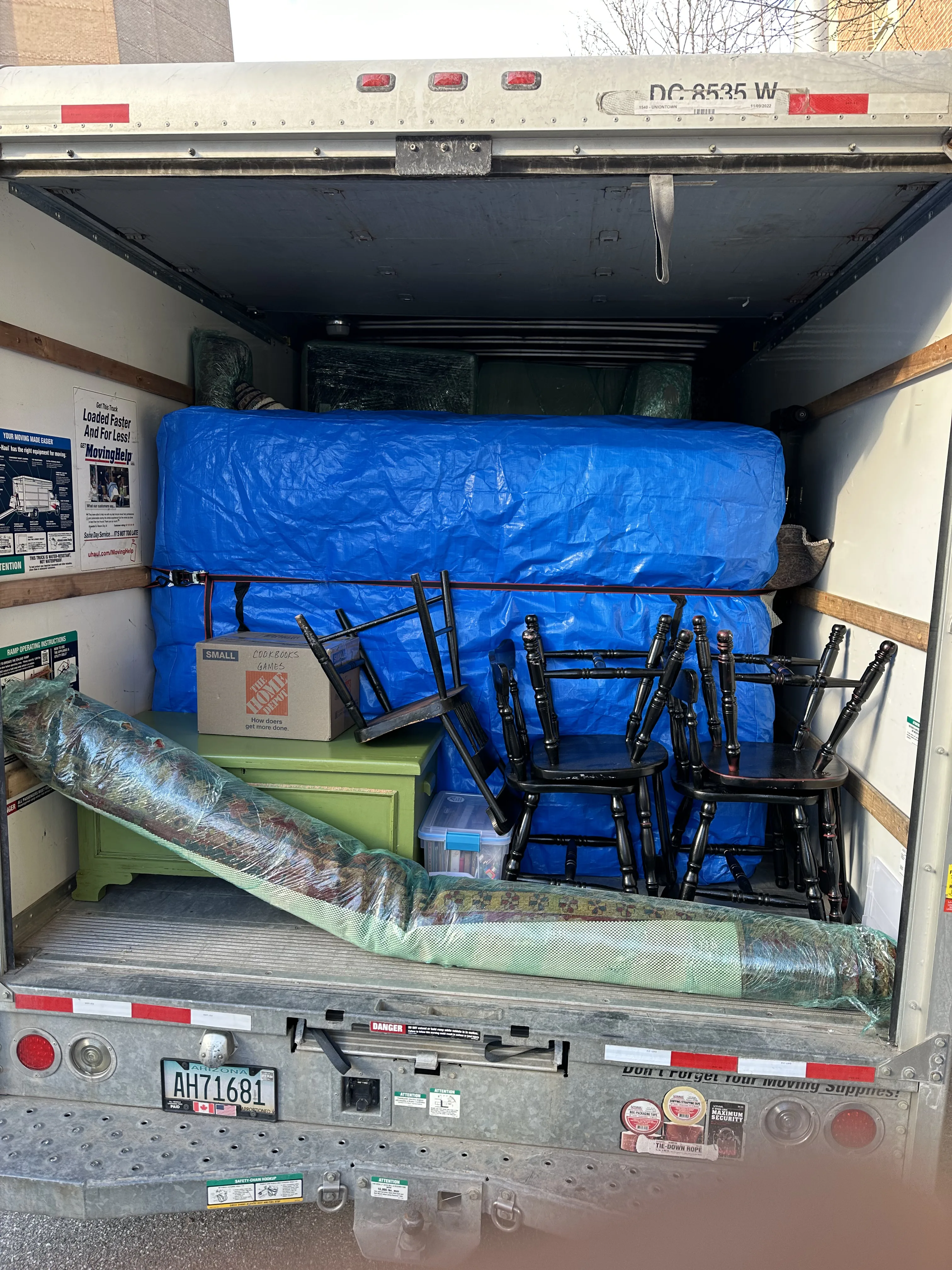 Loaded truck — chairs and mattress secured
