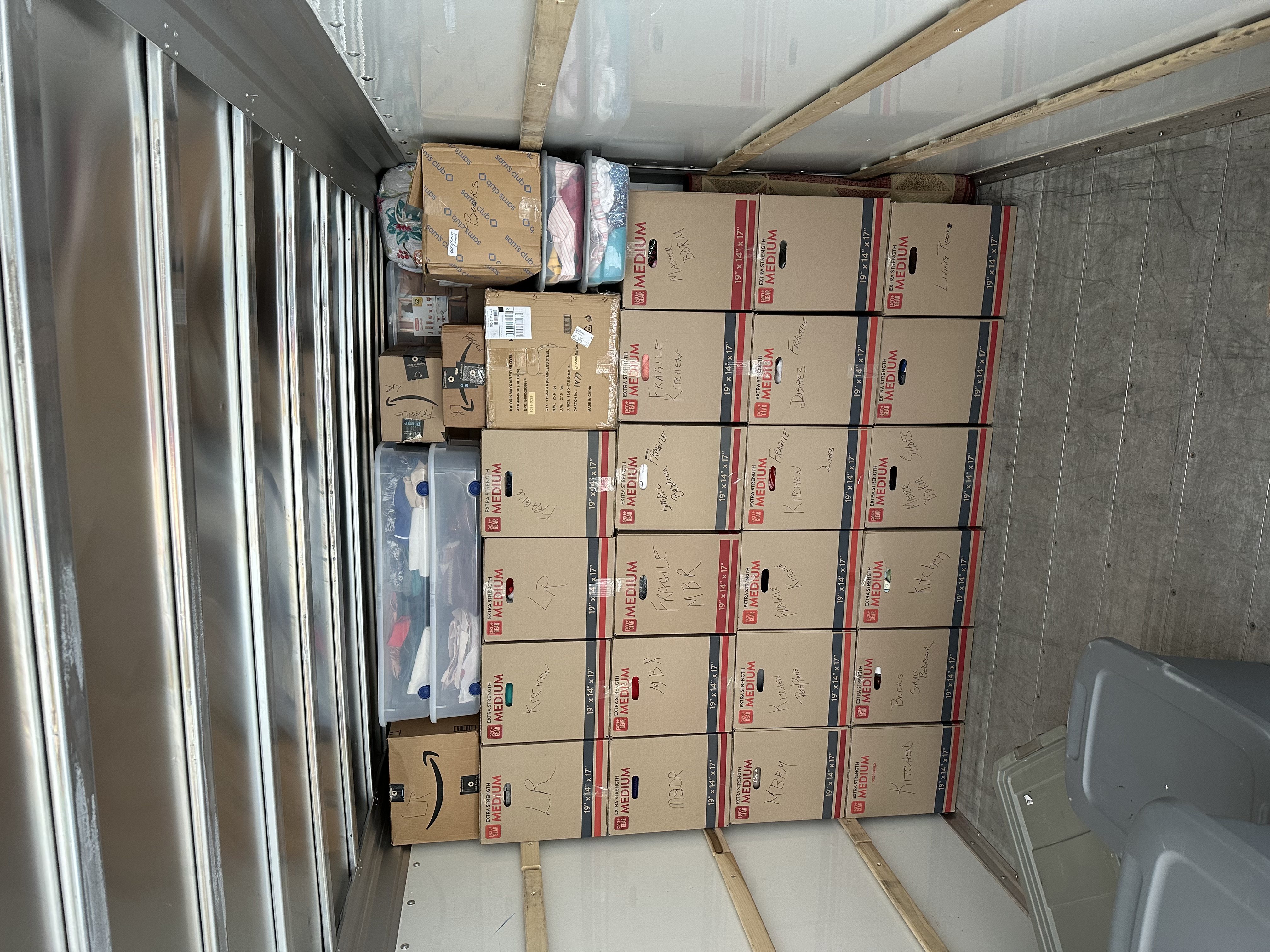 Wall of boxes stacked floor to ceiling in truck