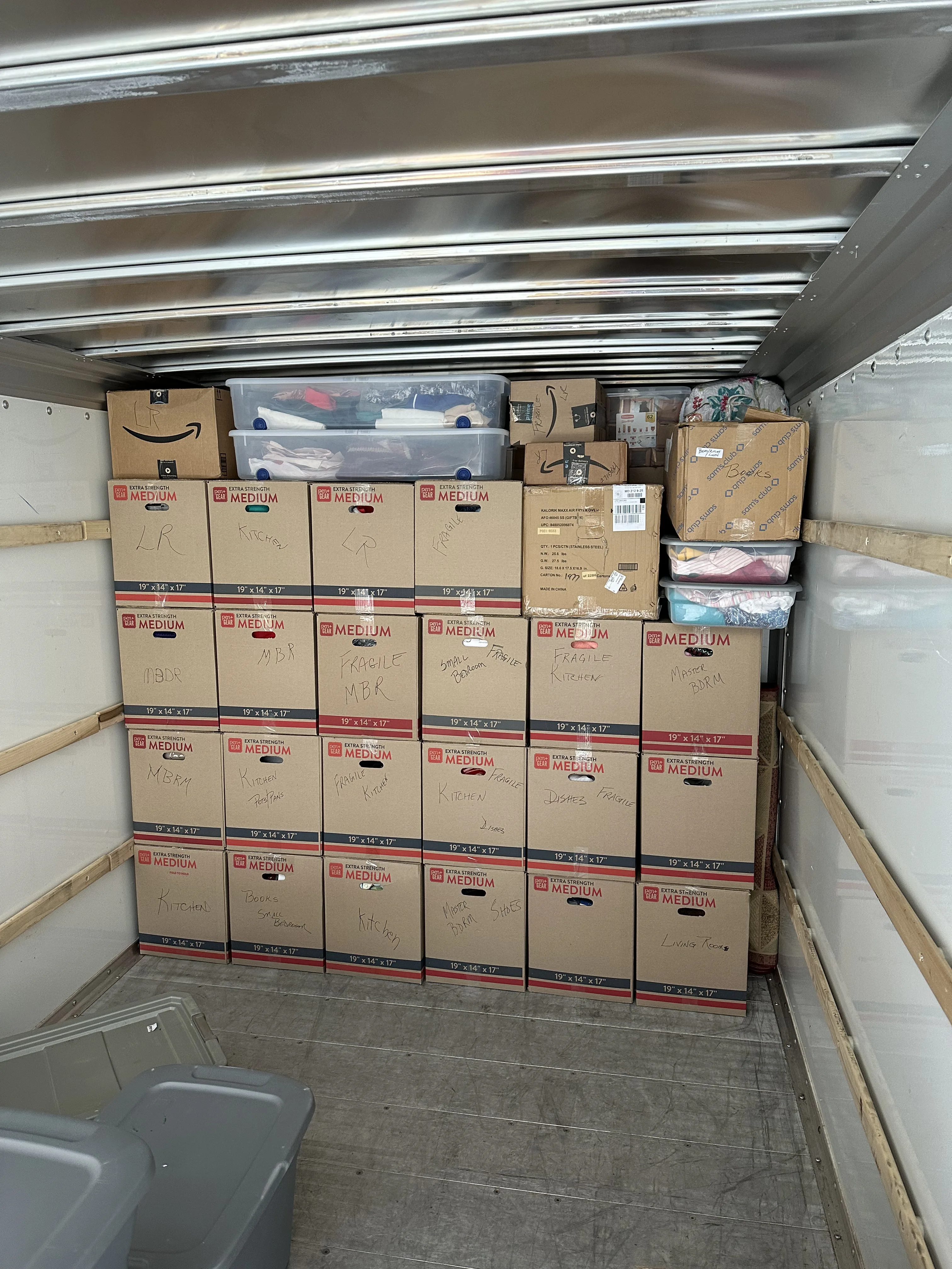Wall of boxes stacked floor to ceiling in truck