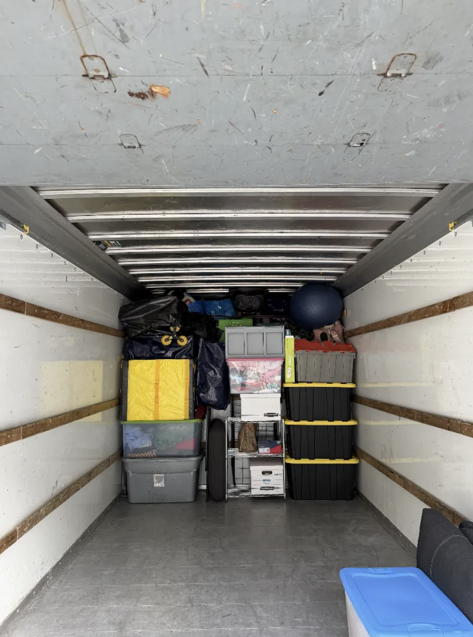 Truck interior loaded with storage bins and household gear