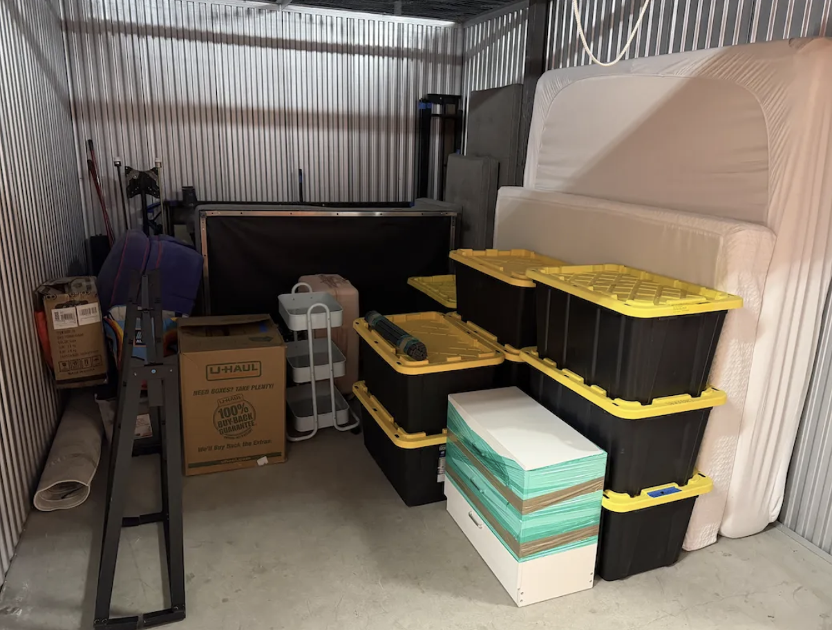 Storage unit organized with stacked totes and furniture