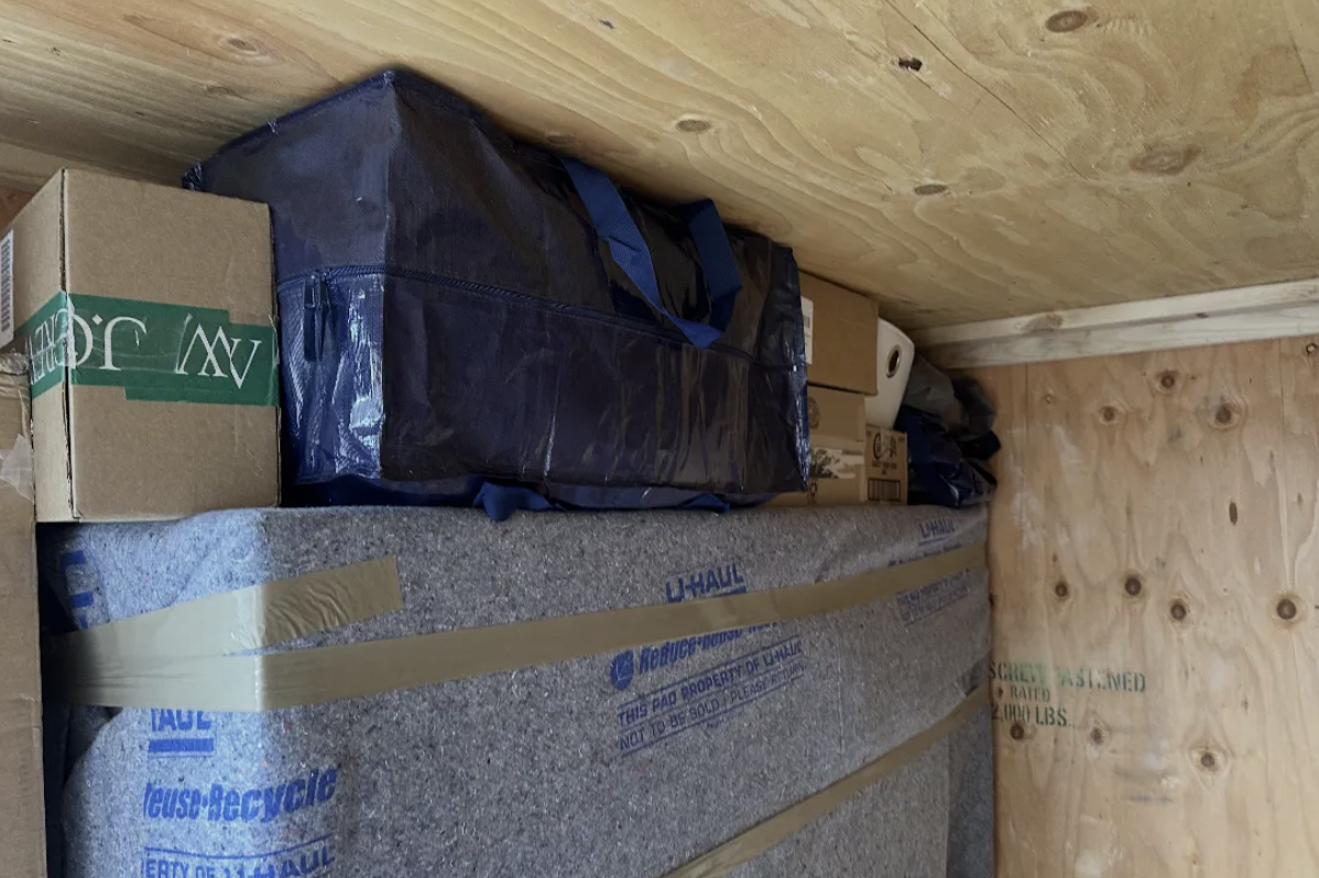 UBox interior — pad-wrapped items and travel bags secured
