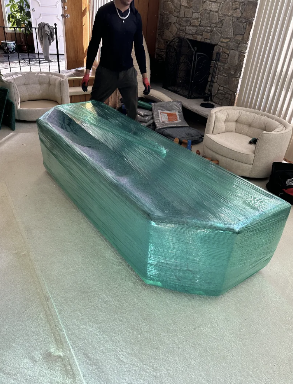 Smart Move crew wrapping a sofa in green stretch film